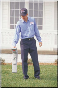 Sewer tech locating an underground sewer line.